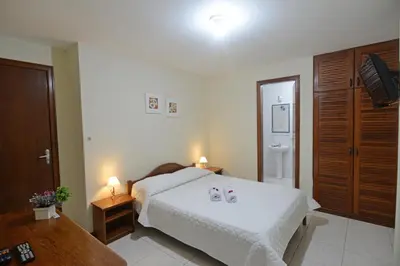 Uma cama ou camas num quarto em Oceano Pousada - Buffet de café da manhã e serviço de quarto diário