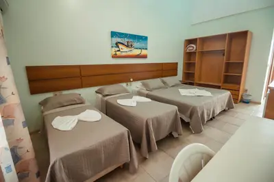 Uma cama ou camas num quarto em Pousada Lugar ao Sol