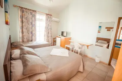 Uma cama ou camas num quarto em Pousada Lugar ao Sol