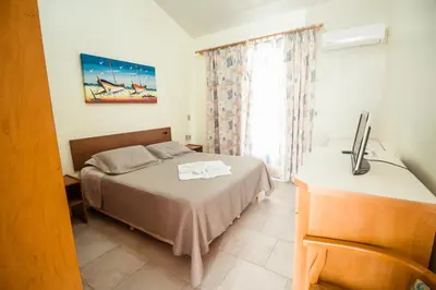 Uma cama ou camas num quarto em Pousada Lugar ao Sol