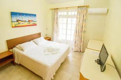Uma cama ou camas num quarto em Pousada Lugar ao Sol