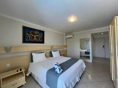 Uma cama ou camas num quarto em Bombinhas Blue Suítes