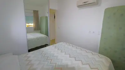 Uma cama ou camas num quarto em 1043 Apartamento a 50 mts da Praia de Bombinhas