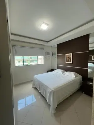 Uma cama ou camas num quarto em Meia Praia com estilo! 3 suítes, churrasqueira e garagem