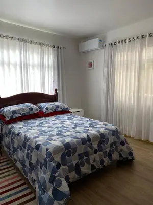 Uma cama ou camas num quarto em Casa Bombinhas