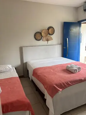 Uma cama ou camas num quarto em Maika'i Pousada