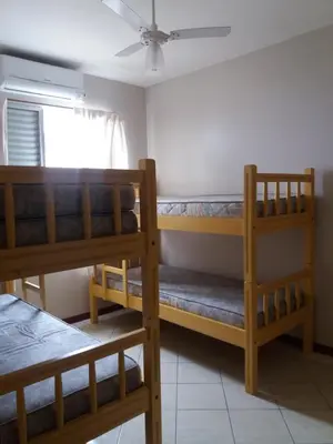 Uma cama ou camas num quarto em Ed. Praia de Palmas SC