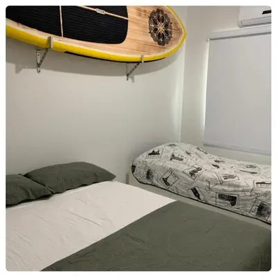 Uma cama ou camas num quarto em BORBOLETAS DO MAR