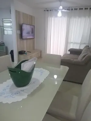 Uma área de estar em Apartamento Praia de Palmas