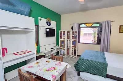 Uma cama ou camas num quarto em Casa de Hóspedes Canto dos Pássaros