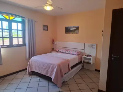 Uma cama ou camas num quarto em Casa de Hóspedes Canto dos Pássaros