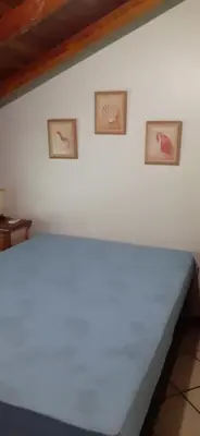 Uma cama ou camas num quarto em Um refúgio à Beira mar