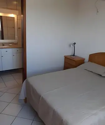 Uma cama ou camas num quarto em Apartamento com VISTA para o MAR no centro de Bombinhas