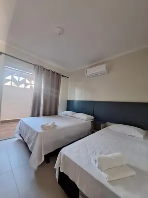Uma cama ou camas num quarto em Bombas Beach