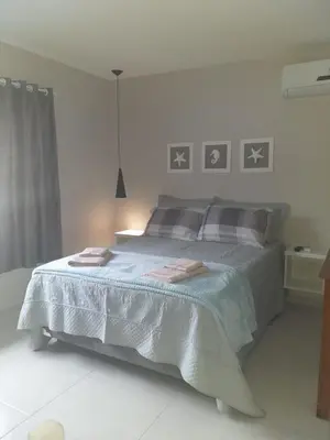 Uma cama ou camas num quarto em Pérola de Bombinhas