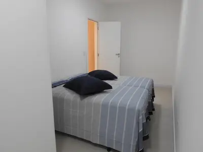 Uma cama ou camas num quarto em Apartamento em Bombinhas