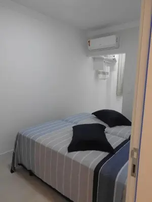 Uma cama ou camas num quarto em Apartamento em Bombinhas