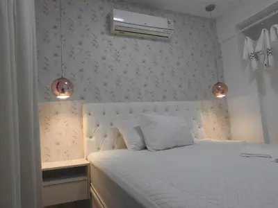 Uma cama ou camas num quarto em Apartamento em Bombinhas