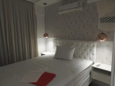 Uma cama ou camas num quarto em Apartamento em Bombinhas