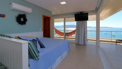 Uma televisão e/ou sistema de entretenimento em Flat Vista para o Mar e Piscina em Bombinhas 1082