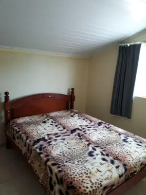 Uma cama ou camas num quarto em Residencial Caxias