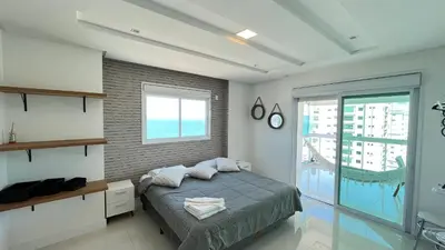 Uma cama ou camas num quarto em COBERTURA com belíssima vista para o mar e jacuzzi