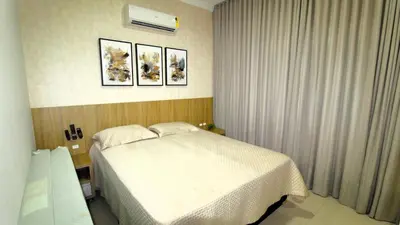 Uma cama ou camas num quarto em 1072 - Apartamento 3 suítes Alto Padrão com SPA na Praia de Bombinhas