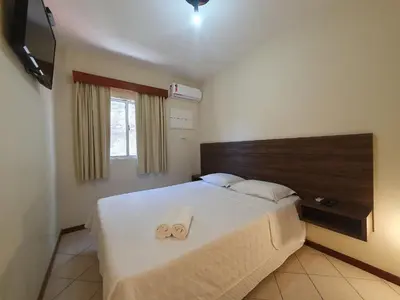 Uma cama ou camas num quarto em Pousada Acapulco
