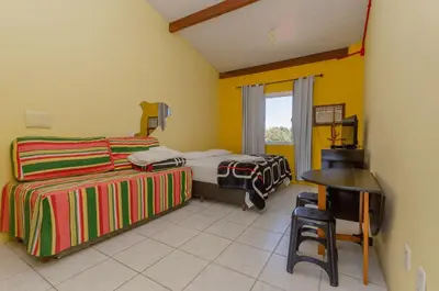 Uma cama ou camas num quarto em Pousada Recanto Dom Arthur