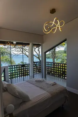 Uma cama ou camas num quarto em Casa Vista Mar com Ofurô - Condomínio com piscina