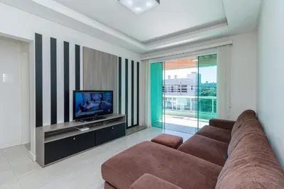 Uma televisão e/ou sistema de entretenimento em Aluguel Apartamento 3 quartos vista mar Bombas SC