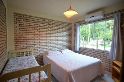 Uma cama ou camas num quarto em Pousada Sítio Olho D'Água