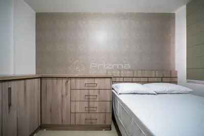 Uma cama ou camas num quarto em Garden Ville · Confortável apartamento na Praia de Bombas com ótima localização