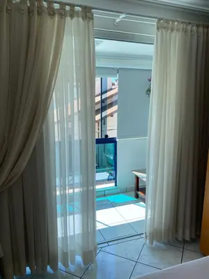 Uma televisão e/ou sistema de entretenimento em Apartamento Aconchegante Beira Mar em Itapema - Santa Catarina