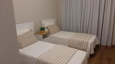 Uma cama ou camas num quarto em Excelente Sobrado Confortável no Centro de Tijucas Próximo as Praias