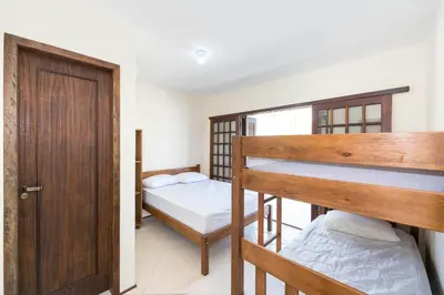 Uma cama ou camas num quarto em Casa Patta - 05 dormitórios, com piscina.
