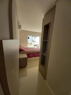 Uma cama ou camas num quarto em Cobertura Bombinhas