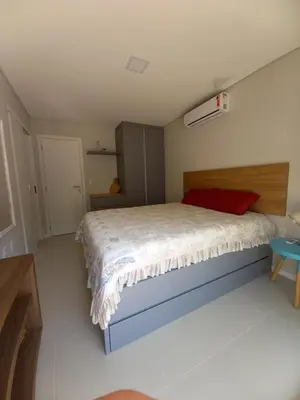 Uma cama ou camas num quarto em Cobertura Bombinhas