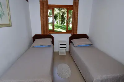 Uma cama ou camas num quarto em BANGALÔ CASA DAS PALMEIRAS - EXCLUSIVIDADE, CONFORTO E PRIVACIDADE.