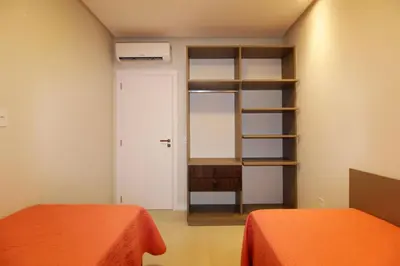 Uma cama ou camas num quarto em 1089 - Praia de Bombinhas novíssimo 02 dormitórios