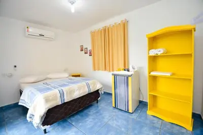 Uma cama ou camas num quarto em Pousada Praia de Bombinhas