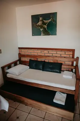 Uma cama ou camas num quarto em Pousada Praia de Bombinhas