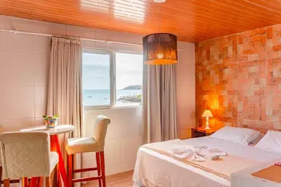 Uma cama ou camas num quarto em Pousada Vila Del Mare - Frente Praia