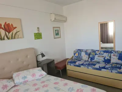 Uma cama ou camas num quarto em PRAIA 4 ILHAS Apartamento 1 Quarto a 50M da Praia