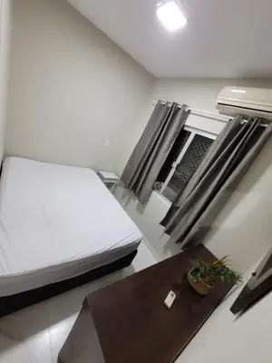 Uma cama ou camas num quarto em Novo Lar Itapema-2