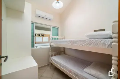 Uma cama ou camas num quarto em Casa com 05 dormitórios ideal as férias na praia