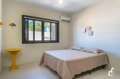 Uma cama ou camas num quarto em Seu Espaço Frente Mar com 4 Dormitórios