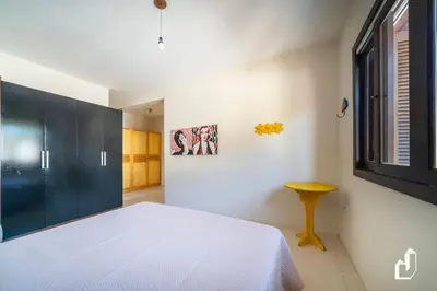 Uma cama ou camas num quarto em Seu Espaço Frente Mar com 4 Dormitórios