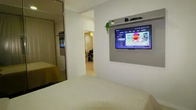 Uma cama ou camas num quarto em 1077 Excelente opção com duas suítes no centro de Bombinhas