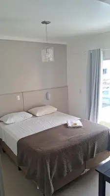 Uma cama ou camas num quarto em Pousada Rota do Sol Bombinhas suíte sem cafe e limpeza - opcional